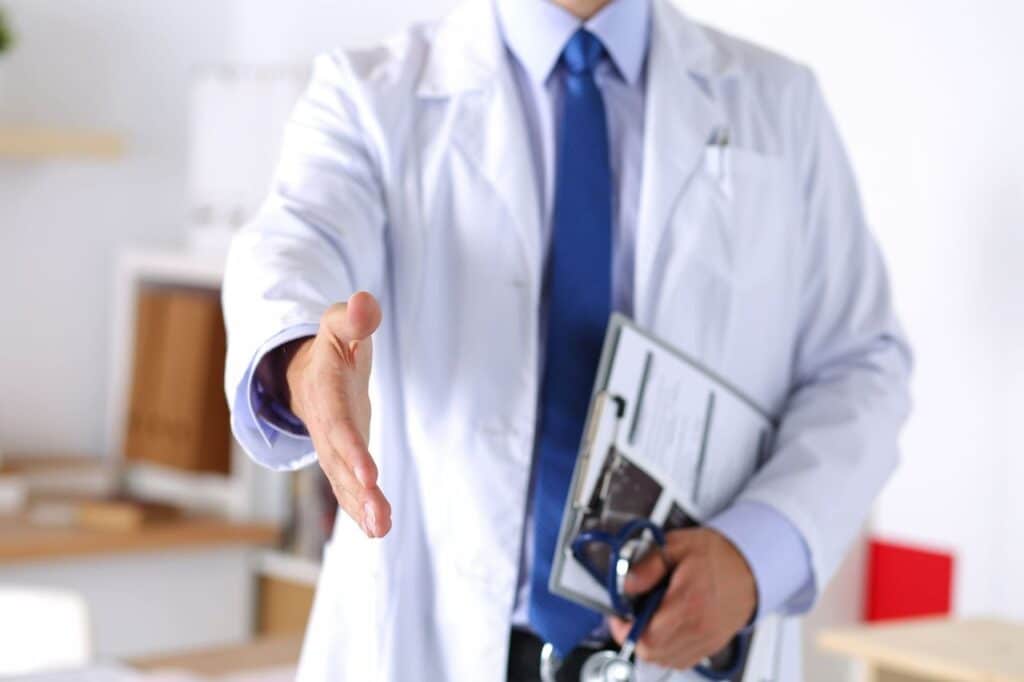 Doctor holds out hand to greet a patient