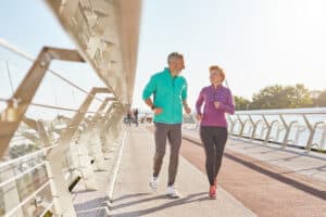 Thriving older couple exercising thanks to their effective concierge medicine doctor